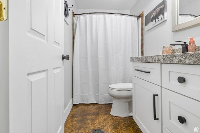 bathroom with toilet, curtained shower, and vanity