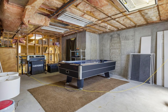 rec room with unfinished concrete floors