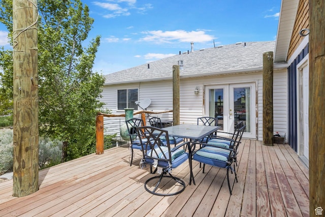 deck with french doors and outdoor dining area