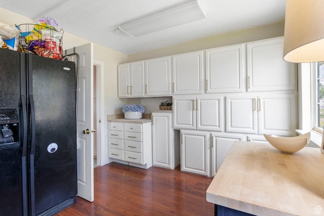 kitchen featuring black fridge with ice dispenser, butcher block countertops, dark wood-type flooring, and white cabinets