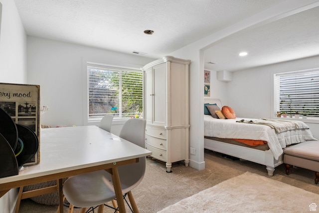 bedroom featuring visible vents, recessed lighting, and light carpet