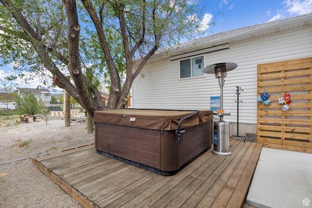 wooden deck featuring a hot tub