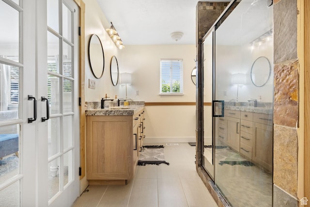 bathroom with french doors, a wealth of natural light, and vanity