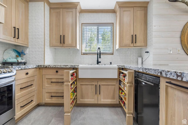 kitchen featuring stainless steel range with gas cooktop, light brown cabinets, a sink, and dishwasher