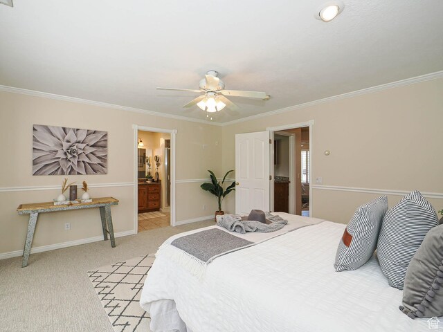 bedroom featuring crown molding, connected bathroom, ceiling fan, light colored carpet, and baseboards