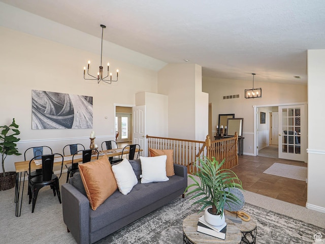living area with visible vents, high vaulted ceiling, and a chandelier