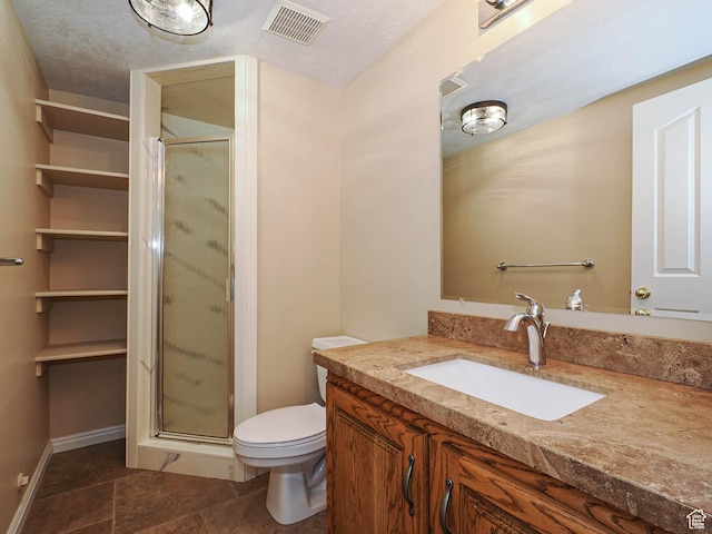 full bathroom featuring vanity, visible vents, a shower stall, and toilet