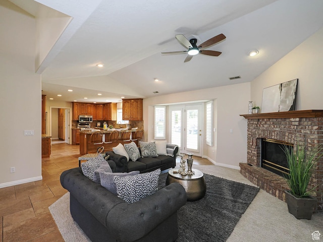 living area featuring ceiling fan, lofted ceiling, visible vents, and baseboards