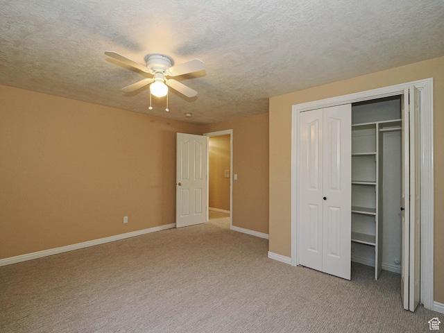 unfurnished bedroom featuring a closet, baseboards, and light carpet