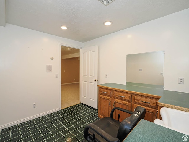 office space with dark tile patterned floors, visible vents, and recessed lighting
