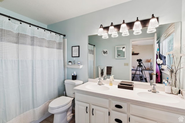 bathroom with a sink, double vanity, toilet, and a shower with curtain