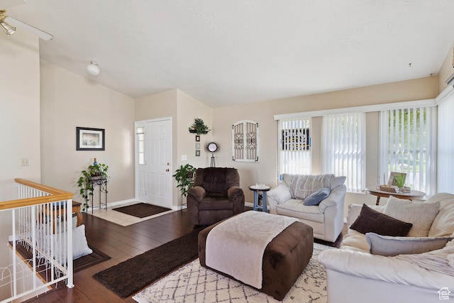 living room with wood-type flooring and baseboards