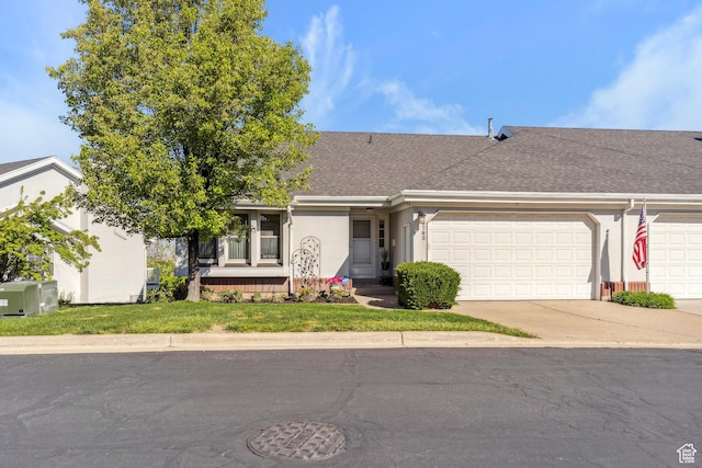 ranch-style house featuring concrete driveway, a shingled roof, stucco siding, and a garage
