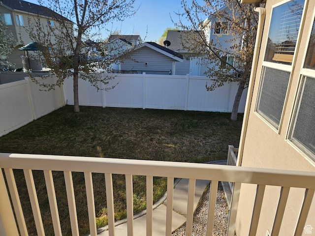 fenced backyard with a balcony