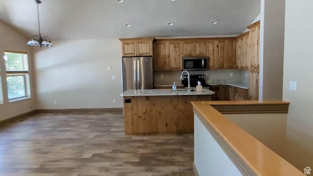 kitchen with stainless steel appliances, a sink, light wood-type flooring, a kitchen island with sink, and recessed lighting