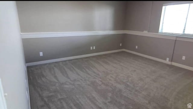 empty room with carpet and baseboards