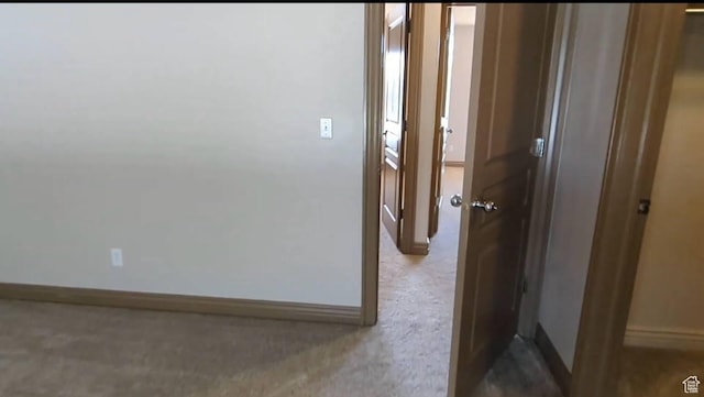hallway featuring baseboards