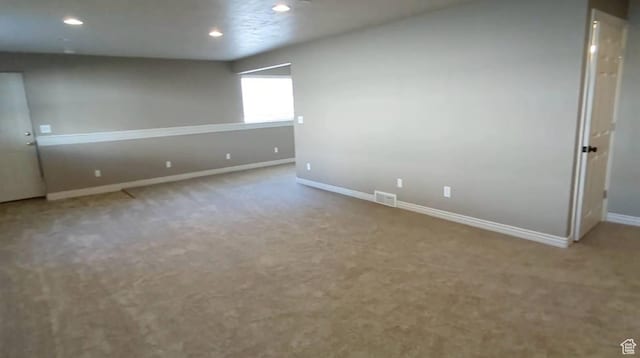 below grade area featuring baseboards, recessed lighting, and carpet floors