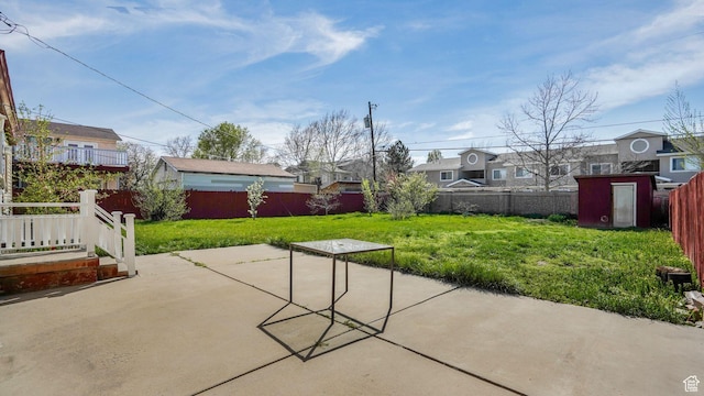 3760 S 3325 W, West Valley City, UT 84119 - view of patio / terrace featuring a fenced backyard, an outbuilding, a storage shed, and a residential view
