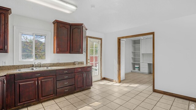 3760 S 3325 W, West Valley City, UT 84119 - kitchen featuring a wealth of natural light, baseboards, a sink, and light tile patterned floors