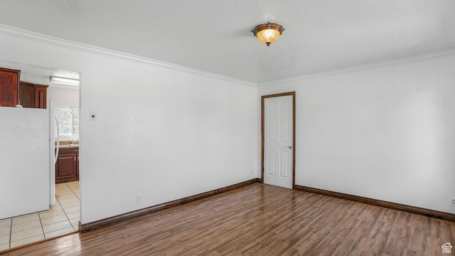3760 S 3325 W, West Valley City, UT 84119 - unfurnished room featuring light wood-type flooring, crown molding, and baseboards