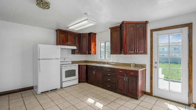3760 S 3325 W, West Valley City, UT 84119 - kitchen featuring under cabinet range hood, baseboards, white appliances, and a sink