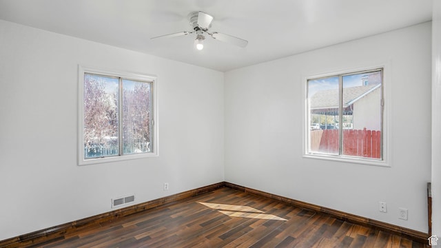 3760 S 3325 W, West Valley City, UT 84119 - spare room with baseboards, visible vents, a wealth of natural light, and dark wood-style floors