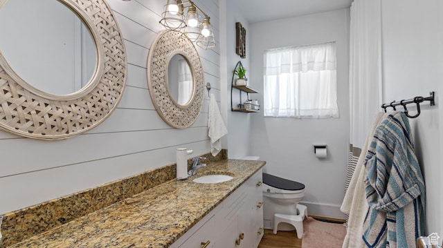 1642 W 2700 S, Syracuse, UT 84075 - bathroom with baseboards, wood finished floors, toilet, and vanity