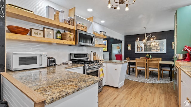 1642 W 2700 S, Syracuse, UT 84075 - kitchen featuring a chandelier, appliances with stainless steel finishes, open shelves, and a peninsula