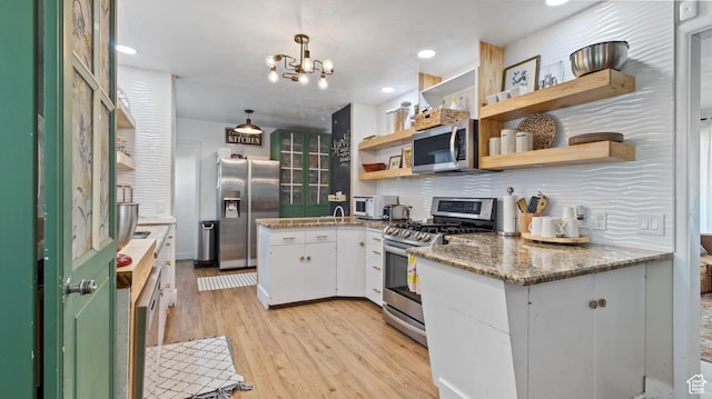 1642 W 2700 S, Syracuse, UT 84075 - kitchen featuring light wood finished floors, stainless steel appliances, open shelves, backsplash, and white cabinetry