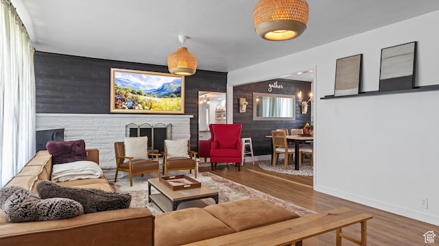 1642 W 2700 S, Syracuse, UT 84075 - living room with baseboards, an accent wall, wood finished floors, and wood walls