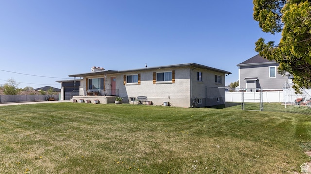 1642 W 2700 S, Syracuse, UT 84075 - back of property featuring fence, a lawn, and brick siding