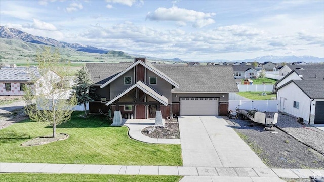 9 W Cedar Ln, Franklin, ID 83237 - view of front of house with driveway, a garage, and a mountain view