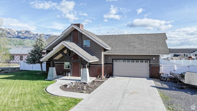 9 W Cedar Ln, Franklin, ID 83237 - view of front of home with concrete driveway, an attached garage, a mountain view, roof with shingles, and a chimney