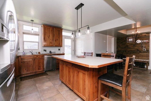 9 W Cedar Ln, Franklin, ID 83237 - kitchen with dishwasher, brown cabinetry, a center island, and healthy amount of natural light