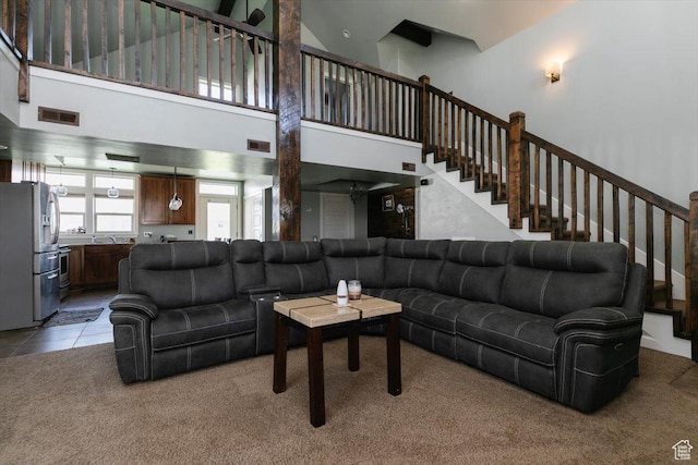9 W Cedar Ln, Franklin, ID 83237 - living area with a towering ceiling, light carpet, and stairs