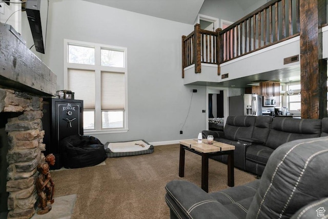9 W Cedar Ln, Franklin, ID 83237 - living room with a high ceiling, carpet, plenty of natural light, a stone fireplace, and baseboards