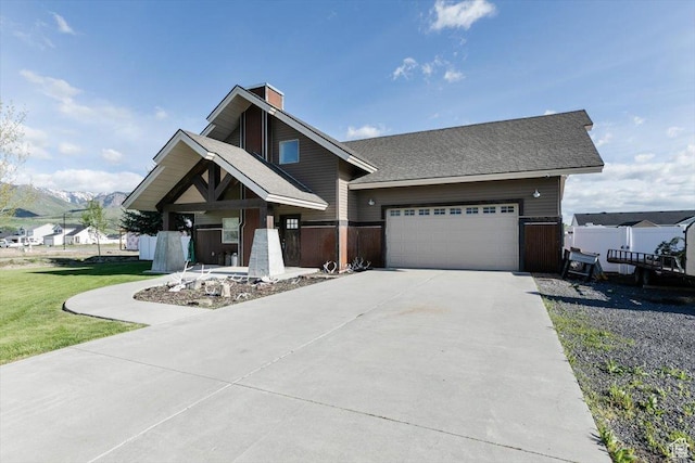 9 W Cedar Ln, Franklin, ID 83237 - craftsman house with concrete driveway, a chimney, and a garage