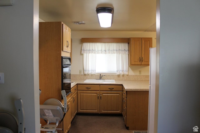 781 Bonneville Way, Tooele, UT 84074 - kitchen with dark colored carpet, a sink, visible vents, light countertops, and black oven
