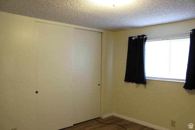781 Bonneville Way, Tooele, UT 84074 - spare room with baseboards, wood finished floors, and a textured ceiling