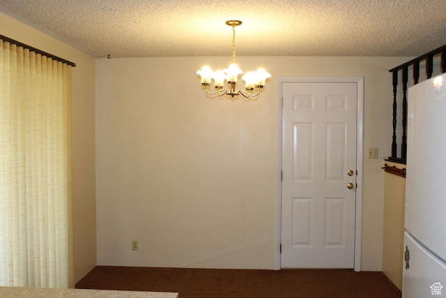 781 Bonneville Way, Tooele, UT 84074 - unfurnished dining area featuring a chandelier, a textured ceiling, and carpet