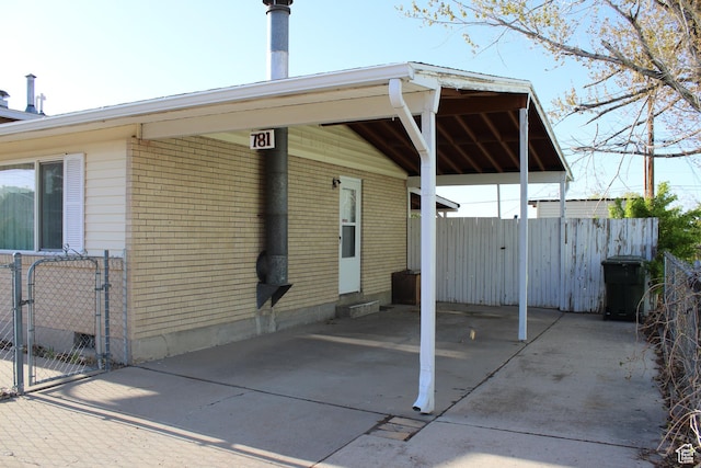 781 Bonneville Way, Tooele, UT 84074 - exterior space with fence, a gate, brick siding, and concrete driveway