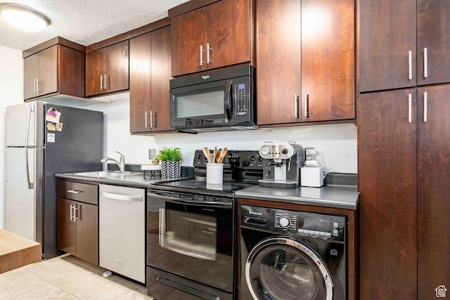 555 E 100 S Unit 105, Salt Lake City, UT 84102 - kitchen with dark brown cabinets, a sink, black appliances, light tile patterned floors, and washer / dryer