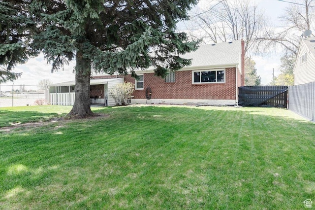 449 S 2nd E, Preston, ID 83263 - rear view of property with a fenced backyard, brick siding, a chimney, and a lawn