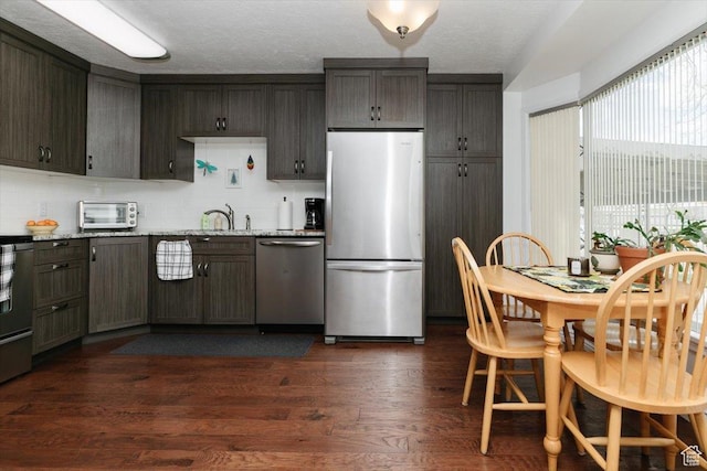 449 S 2nd E, Preston, ID 83263 - kitchen with a sink, a toaster, backsplash, appliances with stainless steel finishes, and dark wood-type flooring