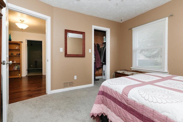 449 S 2nd E, Preston, ID 83263 - carpeted bedroom with a textured ceiling, baseboards, visible vents, a spacious closet, and a closet