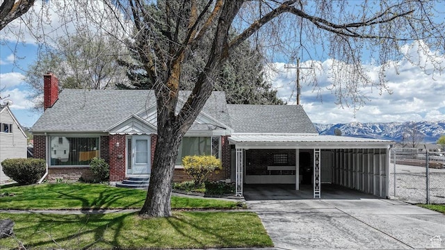449 S 2nd E, Preston, ID 83263 - view of front facade featuring concrete driveway, a carport, fence, a front yard, and brick siding