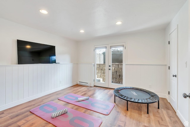 2696 W Red Robin Ct, Lehi, UT 84043 - workout room with wainscoting, a baseboard heating unit, french doors, and wood finished floors