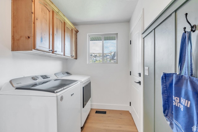2696 W Red Robin Ct, Lehi, UT 84043 - washroom with washing machine and clothes dryer, baseboards, visible vents, light wood-style floors, and cabinet space