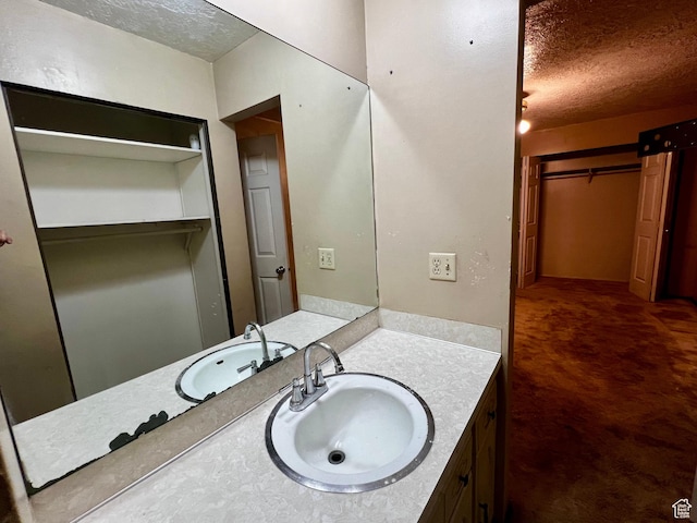 bathroom with vanity and a textured ceiling